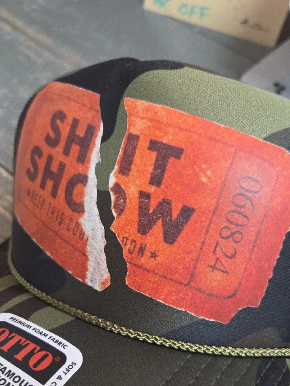 OTTO Camouflage Trucker Hat with Torn Shit Show Ticket